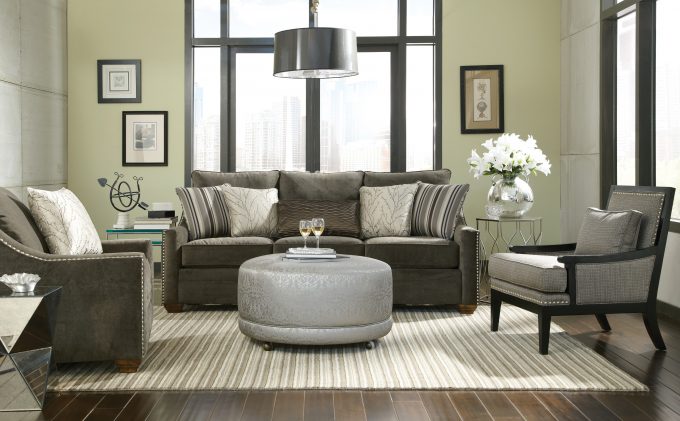 Elegant Beige Sofas With Round Ottoman Coffee Table By Seaside Furniture And Striped Rugs On Laminate Wood Flooring Plus Pendant Lighting